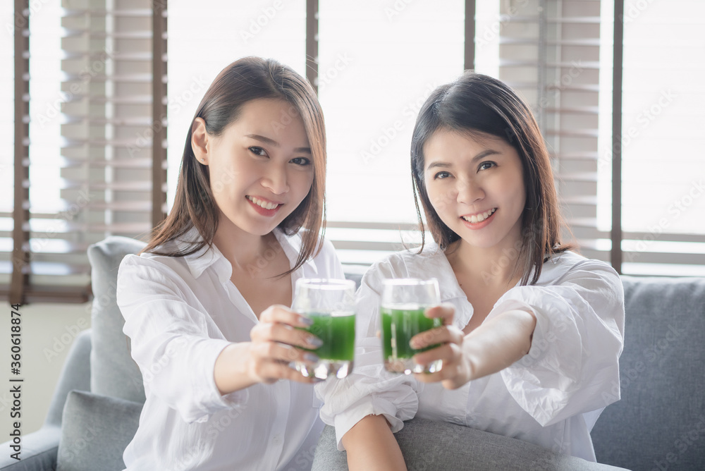 Two beautiful woman enjoy drinking healthy drink during stay safe at home Two beautiful woman enjoy drinking healthy drink during stay safe at home