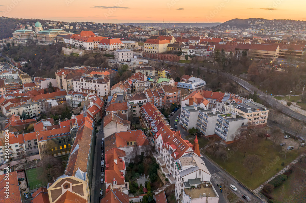 Aerial drone shot of Buda castle on hill during Budapest sunset hour