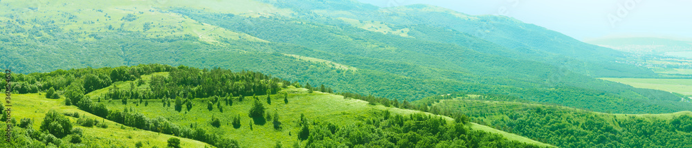 Panorama of mountain range landscape. Forested mountains, summer day, top panoramic view on National nature park Panorama of mountain range landscape. Forested mountains, summer day, top panoramic view on National nature park