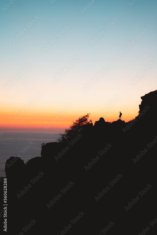 Lonely hiker silhouette during sunset in Jaizkibel, Basque Country