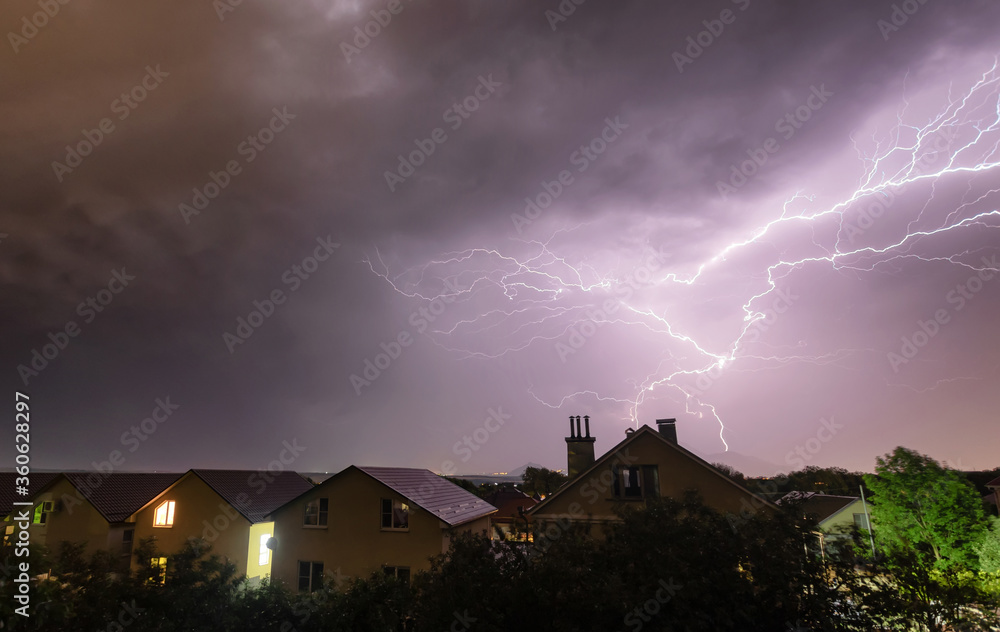 A flash of lightning against the evening sky