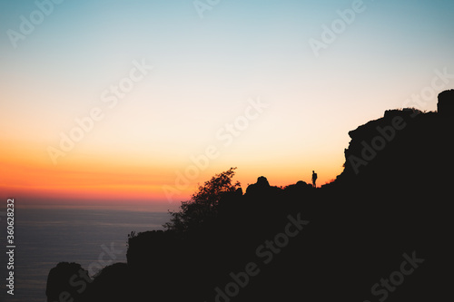 Lonely hiker silhouette during sunset in Jaizkibel, Basque Country