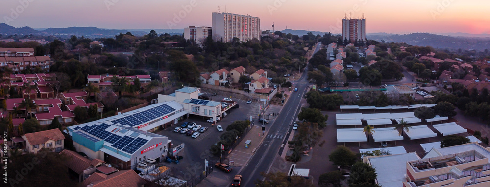 aerial panoramic view of the suburb with apartments and houses at sunset