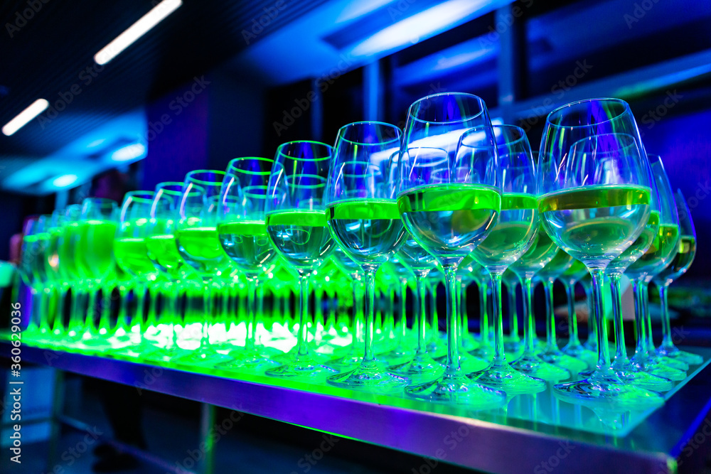 glasses of red wine and glasses of champagne in the green light glasses of red wine and glasses of champagne in the green light