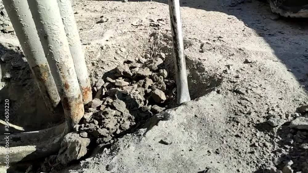 a man works with a jackhammer and hollows a concrete path
a man works with a jackhammer and hollows a concrete path