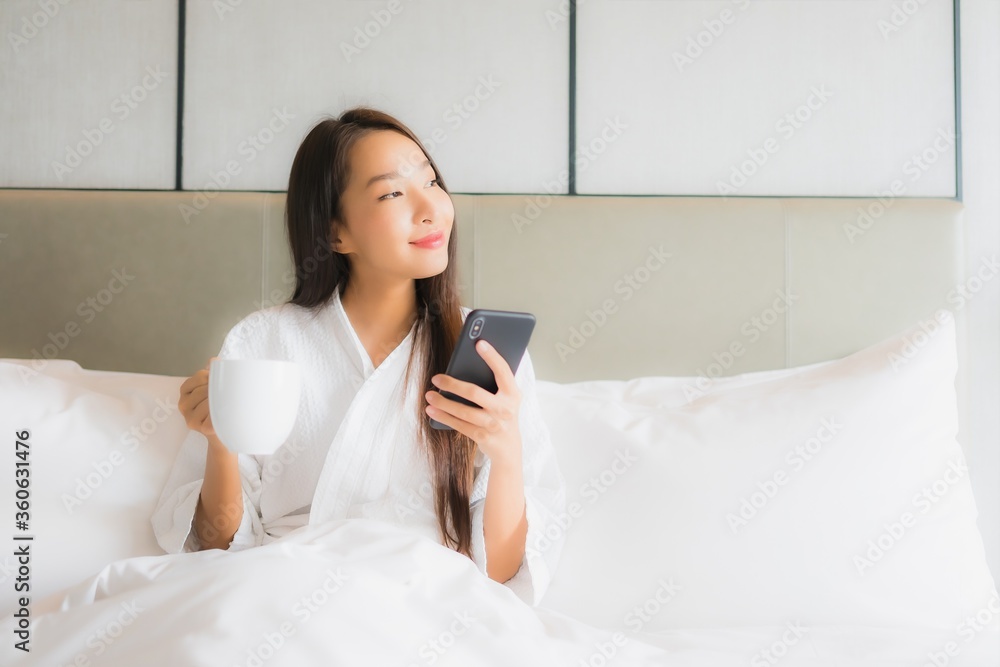 Portrait beautiful young asian woman use smart mobile phone in bedroom Portrait beautiful young asian woman use smart mobile phone in bedroom
