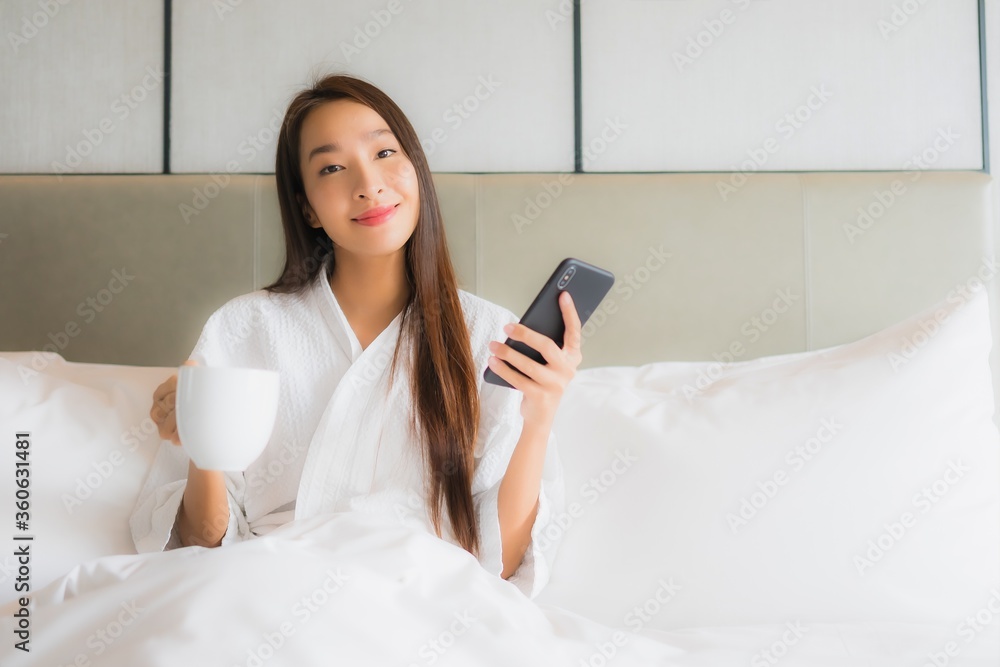 Portrait beautiful young asian woman use smart mobile phone in bedroom Portrait beautiful young asian woman use smart mobile phone in bedroom