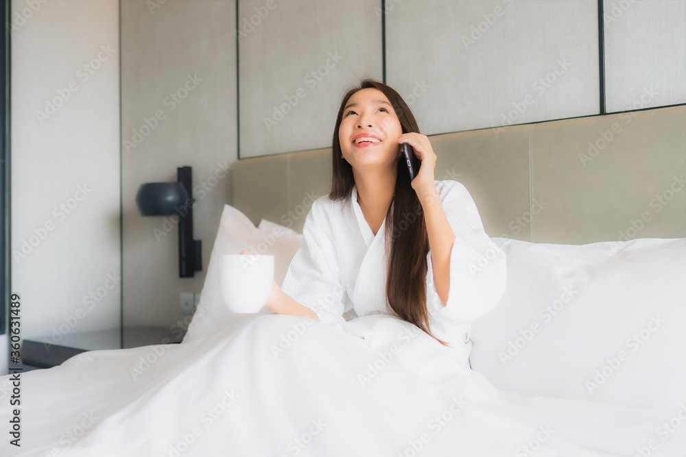 Portrait beautiful young asian woman use smart mobile phone in bedroom Portrait beautiful young asian woman use smart mobile phone in bedroom
