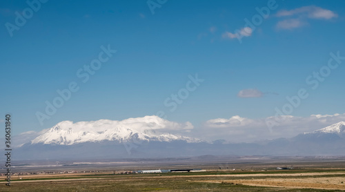 snowy mountain peaks sky,the plain in the foreground