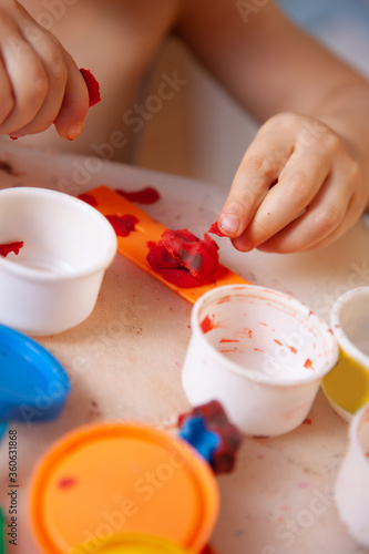 toddler hands close-up. child sculpts from plasticine