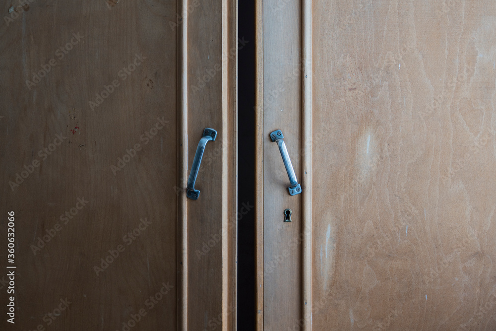 A vintage wooden wardrobe cabinet door and keyhole 