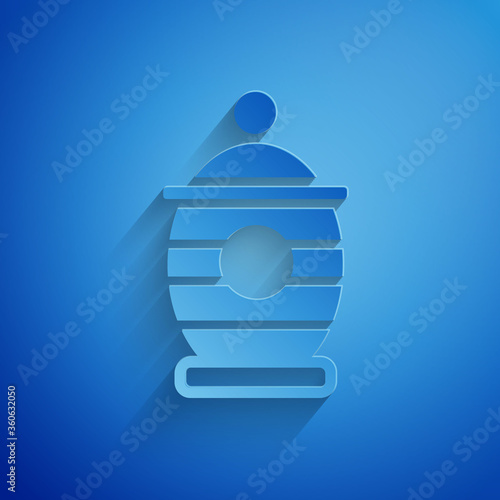 Paper cut Funeral urn icon isolated on blue background. Cremation and burial containers, columbarium vases, jars and pots with ashes. Paper art style. Vector.