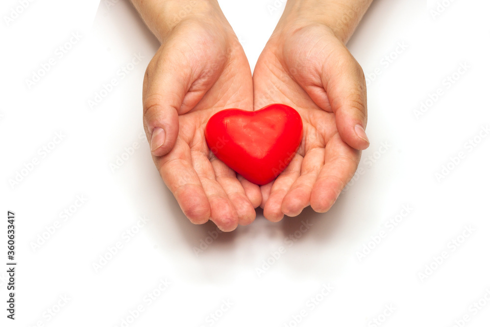 Red heart in woman hands on white backgound
