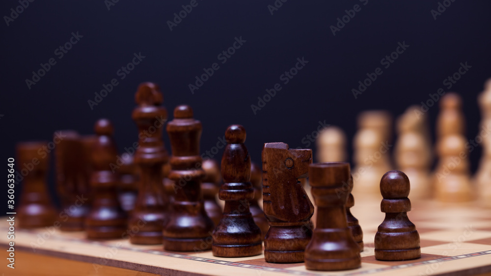 Wooden chess in a contrasting light. A game of chess, an intellectual competition, Wooden chess in a contrasting light. A game of chess, an intellectual competition,