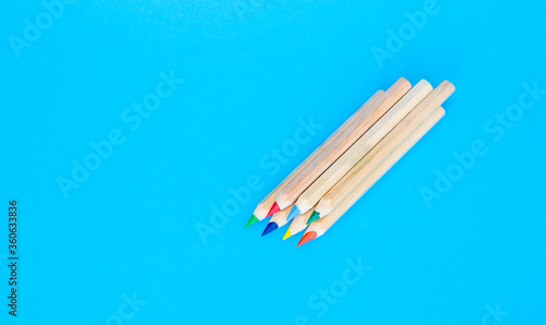 color wooden pencils on a blue background. natural color. Art and hobby tools, a set of colorful stationery