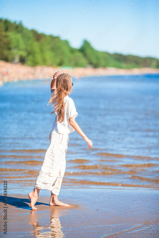 Adorable little girl at beach during summer vacation Adorable little girl at beach during summer vacation