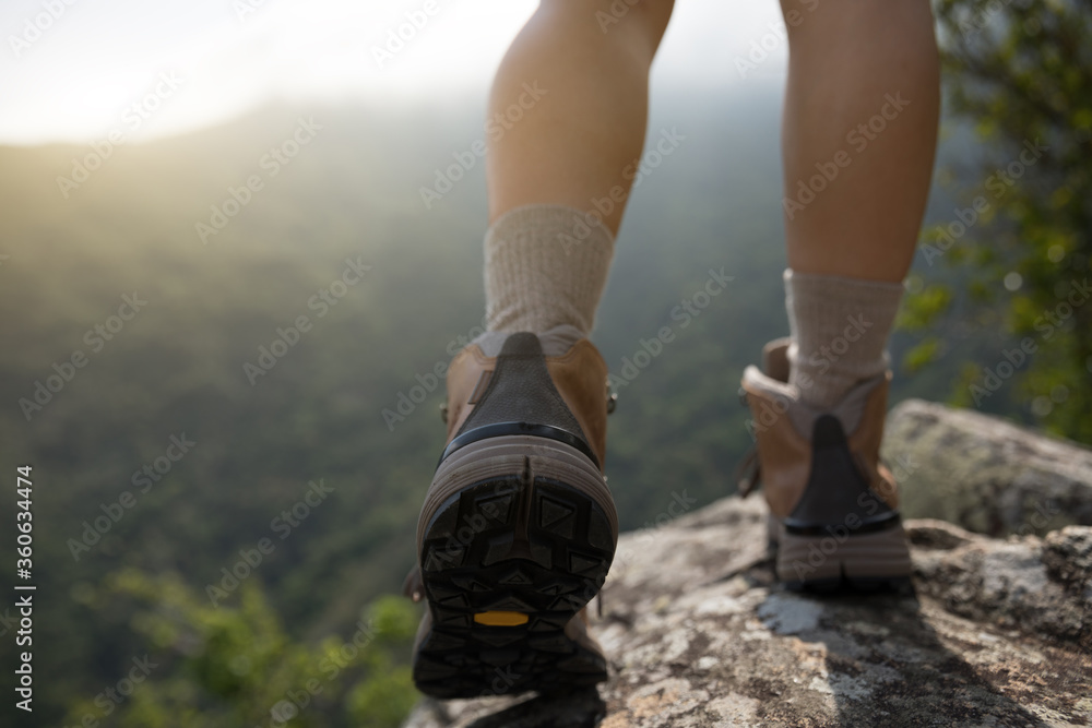 Successful hiker enjoy the view on mountain top cliff edge Successful hiker enjoy the view on mountain top cliff edge