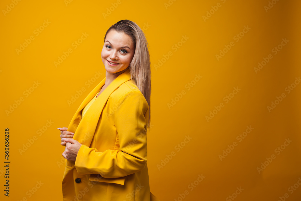 Stylish positive young woman on yellow background, copy space. Stylish positive young woman on yellow background, copy space.