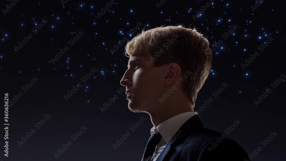 young male businessman on the background of the starry sky. young male businessman on the background of the starry sky.