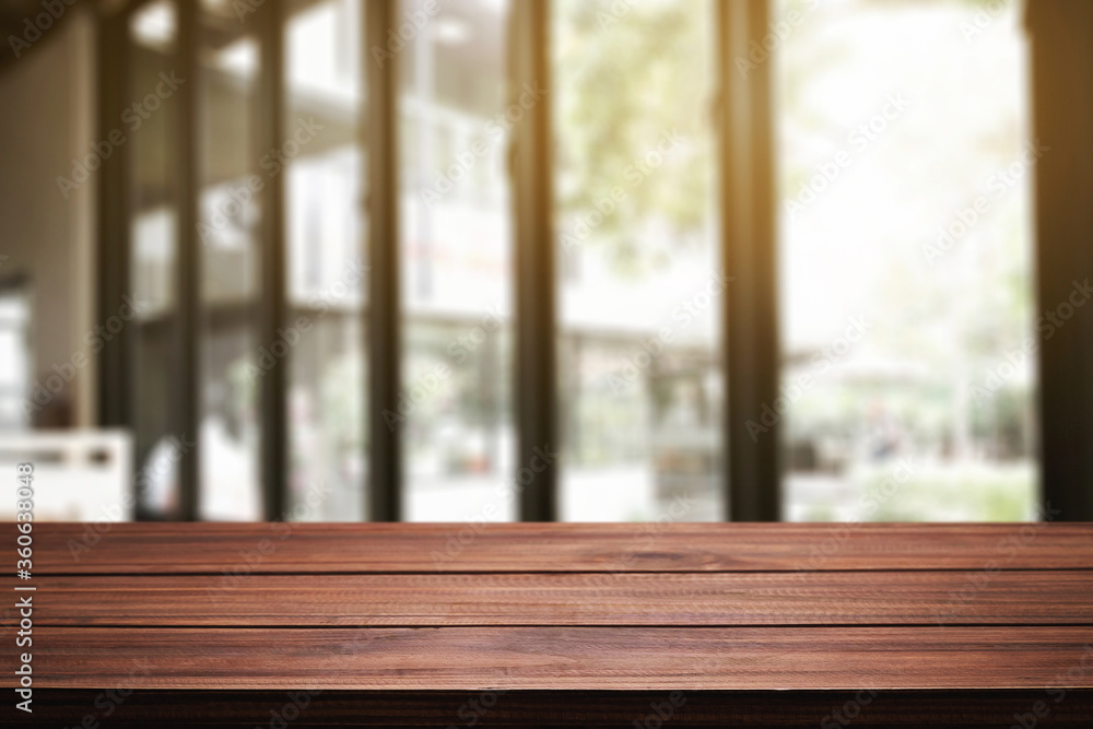 Empty wooden desk space and blurry background of restaurant vintage tone for product display montage Empty wooden desk space and blurry background of restaurant vintage tone for product display montage