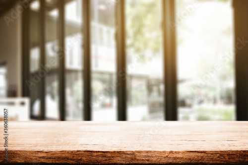 Empty wooden desk space and blurry background of restaurant vintage tone for product display montage