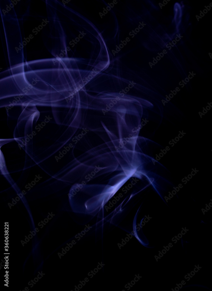 A realistic shot of a wisp of purple smoke against a black background - great for a cool background