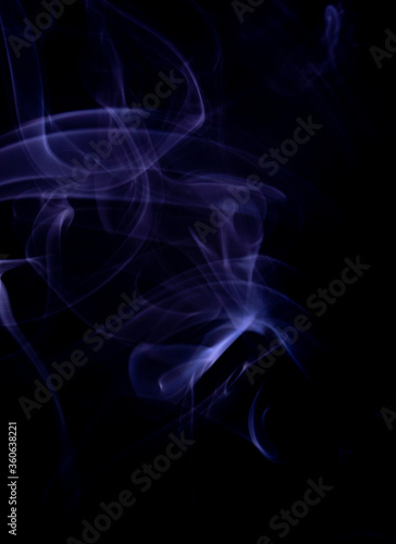 A realistic shot of a wisp of purple smoke against a black background - great for a cool background