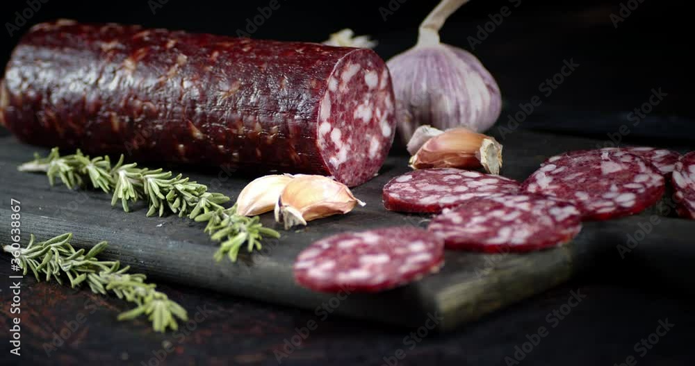 Cut into pieces salami with cloves of garlic slowly rotates. Cut into pieces salami with cloves of garlic slowly rotates.