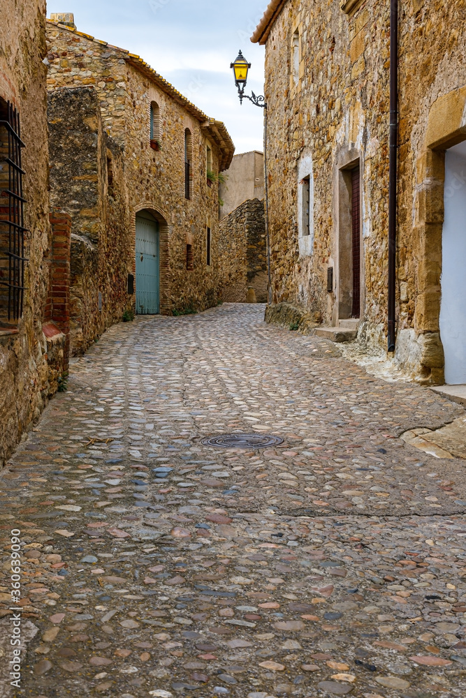 Old town street with lantern in Begur, Girona, Spain