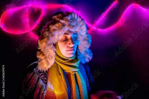 Arabic muslim girl with beatiful colored lights behind her