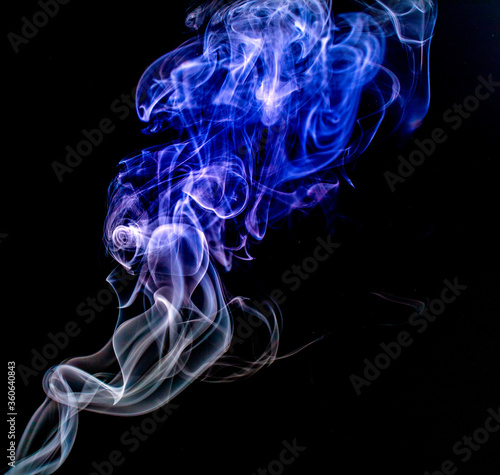 A closeup shot of smoke swirls against a black background