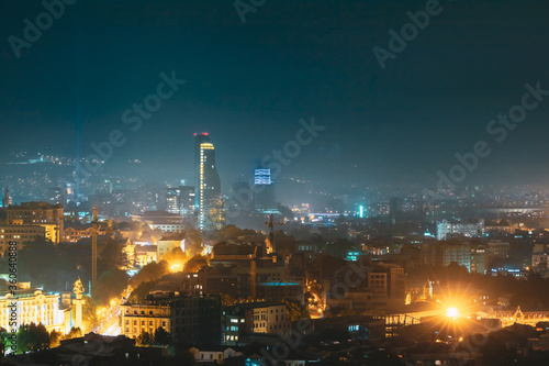 Tbilisi, Georgia. Evening Night Scenic View Of Skyscraper. Street Night Illumination. Construction Development Of Modern Architecture