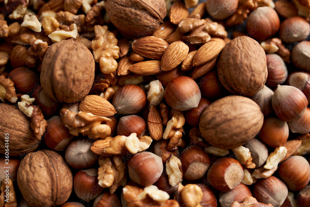 Mix of different nuts, background with walnuts, almonds and hazenuts Mix of different nuts, background with walnuts, almonds and hazenuts