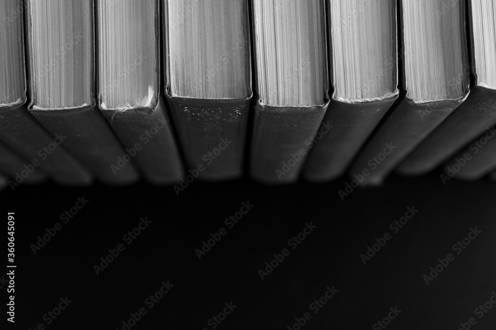 Books in a row on a black background Books in a row on a black background