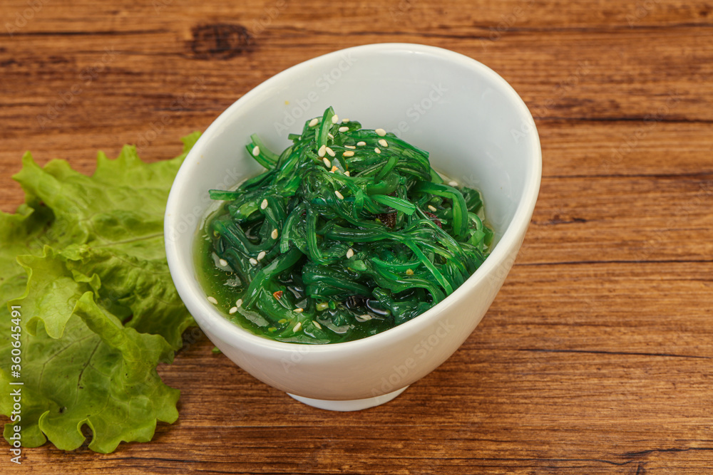 Green Chuka Seaweed Salad Isolated on White Background Top View. Wakame Sea Kelp Salat Green Chuka Seaweed Salad Isolated on White Background Top View. Wakame Sea Kelp Salat