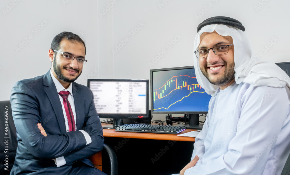 Two arabic muslim men discussing market trend and stocks Two arabic muslim men discussing market trend and stocks