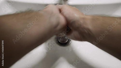 A man washes his hands during the pandemic.