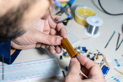 Guy holding electronic parts with his hand