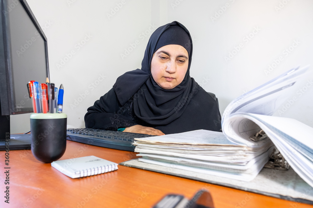Muslim arabic employee checking paper Muslim arabic employee checking paper