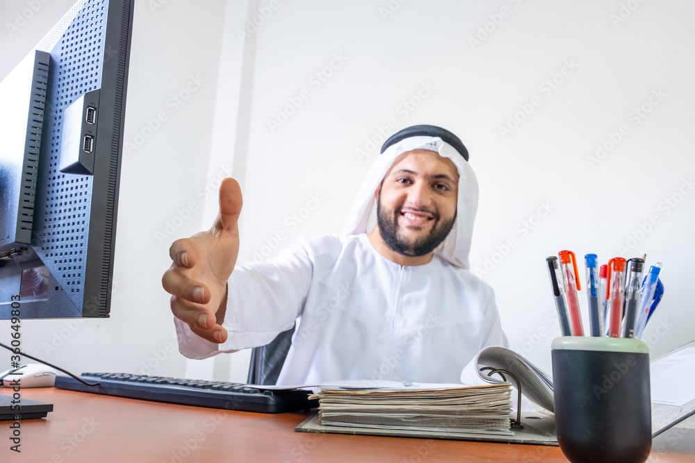 Arabic muslim manager standing to weclome his guest Arabic muslim manager standing to weclome his guest