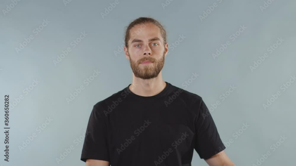 Human Shut Close up man looking at camera serious and tearing tape from her mouth ...