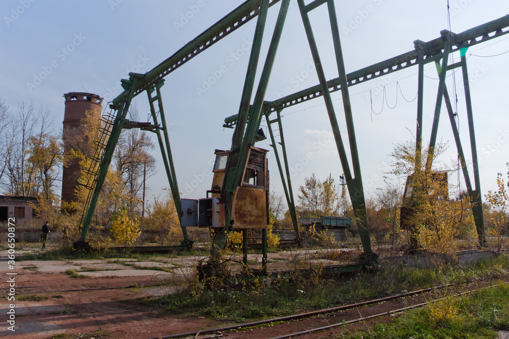 Old rusty gantry bridge crane in abandoned industrial area Old rusty gantry bridge crane in abandoned industrial area