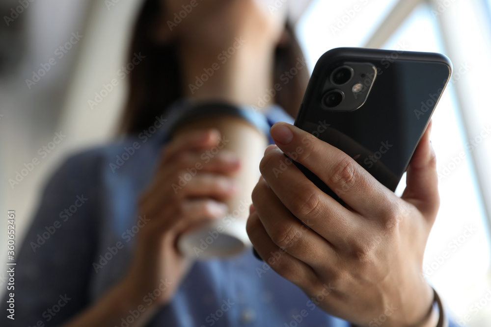 MYKOLAIV, UKRAINE - MARCH 16, 2020: Woman holding iPhone 11 Black indoors, closeup MYKOLAIV, UKRAINE - MARCH 16, 2020: Woman holding iPhone 11 Black indoors, closeup