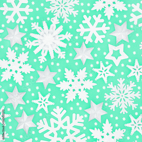 Wallpaper Mural Winter & Christmas snowflake & silver star background pattern on pastel green. Festive composition for Xmas & New Year holiday season. Top view, flat lay.  Torontodigital.ca