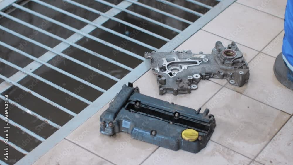 Automobile mechanic cleaning car details with highpressure cleaning Automobile mechanic cleaning car details with highpressure cleaning