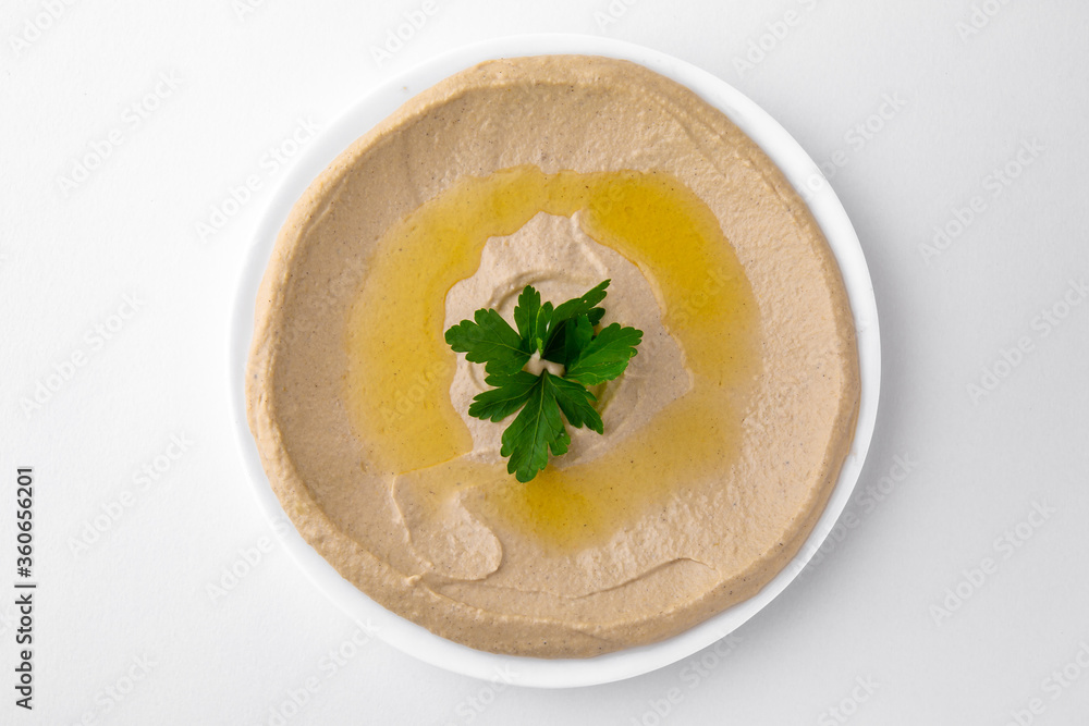 Hummus. A dish of crushed chickpeas for delivery, or online store. Isolated on a white background. Hummus. A dish of crushed chickpeas for delivery, or online store. Isolated on a white background.