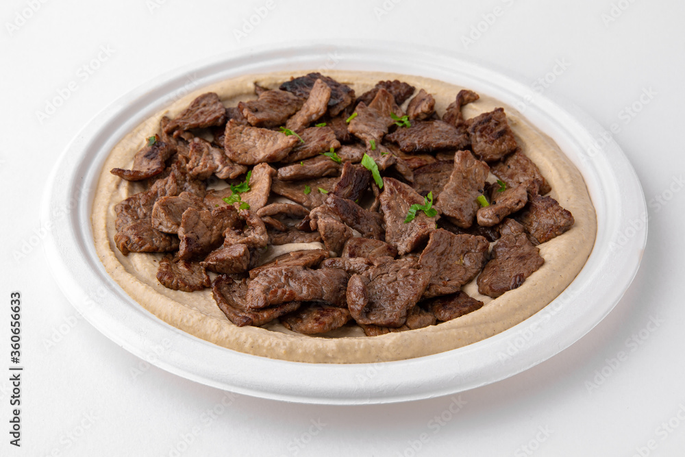 Hummus with beef . A dish of crushed chickpeas for delivery, or online store. Isolated on a white background. Hummus with beef . A dish of crushed chickpeas for delivery, or online store. Isolated on a white background.