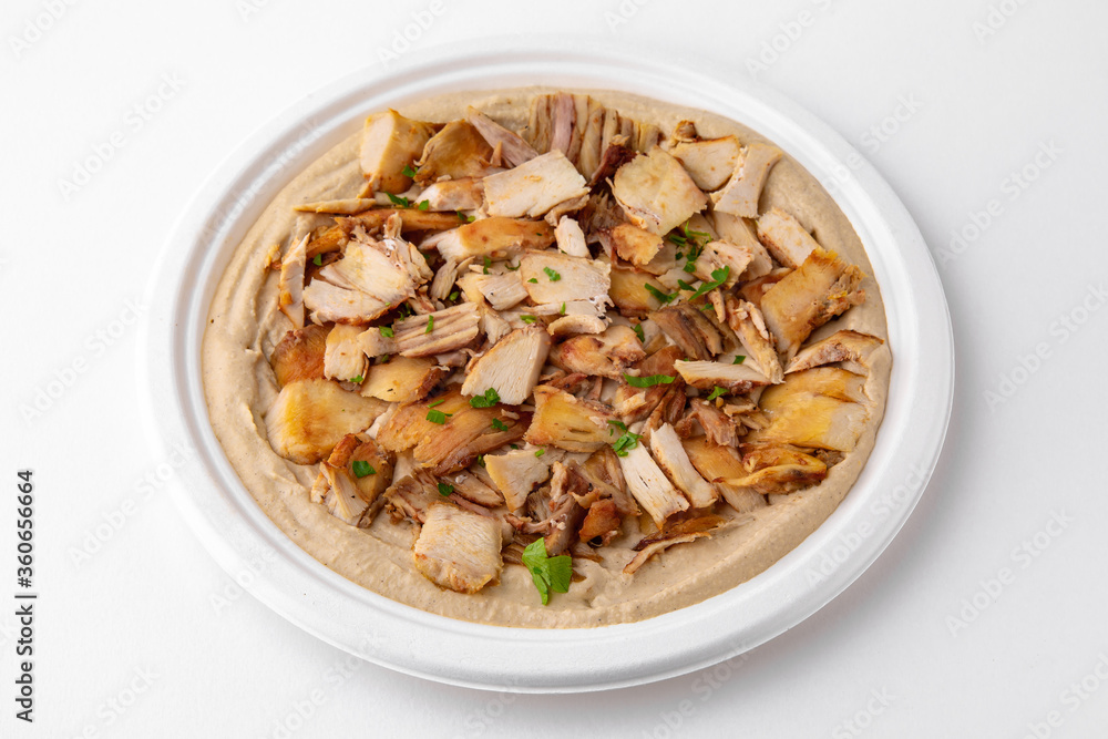 Hummus with chicken. A dish of crushed chickpeas for delivery, or online store. Isolated on a white background. Hummus with chicken. A dish of crushed chickpeas for delivery, or online store. Isolated on a white background.