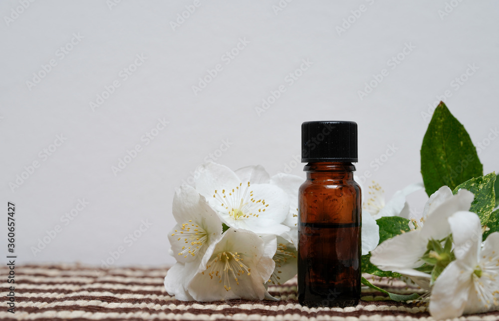 Spa still life with essential oil and white jasmine flowers Spa still life with essential oil and white jasmine flowers