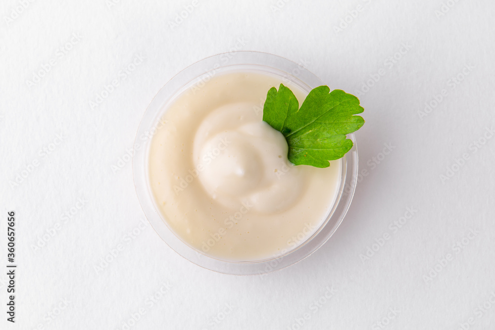 A serving of cream sour cream. Topping for dishes for delivery. Isolated on a white background. A serving of cream sour cream. Topping for dishes for delivery. Isolated on a white background.